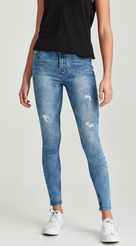 mid length low waisted ripped blue jean