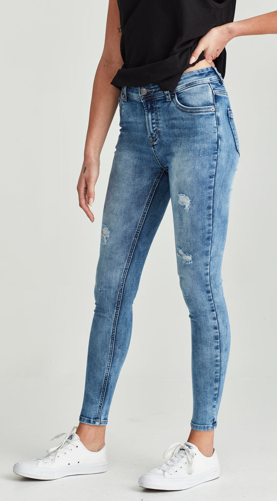 mid length low waisted ripped blue jean
